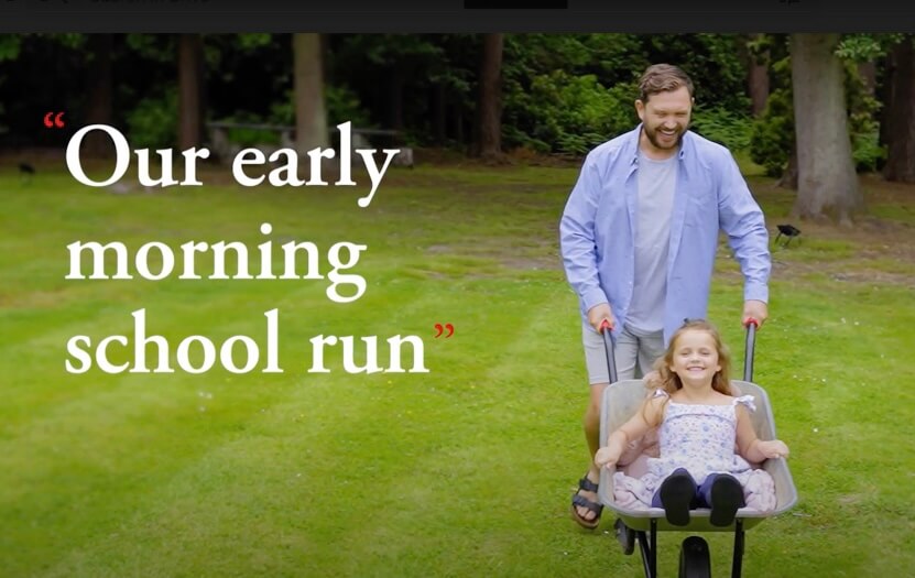 Man having fun with daughter in wheel barrow