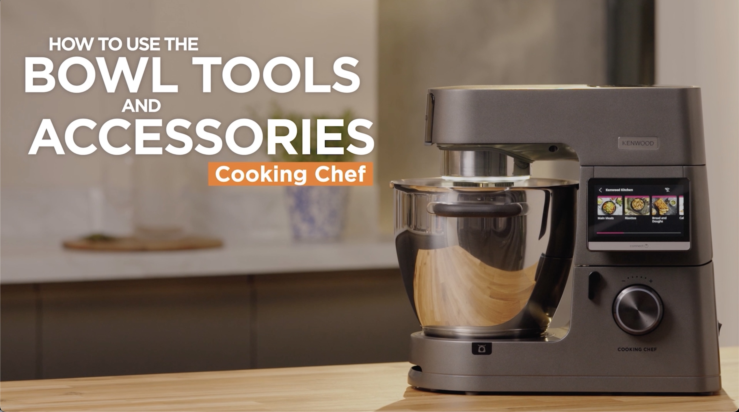 A sleek kitchen mixer with a digital touchscreen is placed on a wooden counter. The text reads How to use the bowl tools and accessories: Cooking Chef in bold letters. The background shows a blurred kitchen setting.