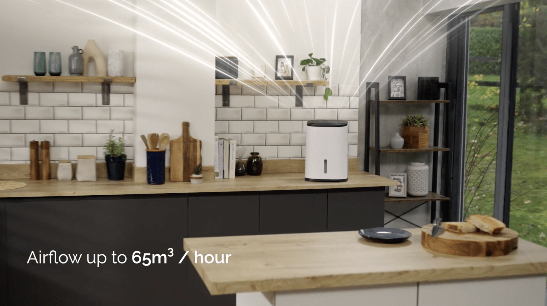 A modern kitchen with wooden countertops, white tile backsplash, and shelves holding dishes and decor. A white air purifier emits illustrated airflow lines. On-screen text reads, Airflow up to 65m³/hour. Perfect inspiration for Outdoor Cooking Videos enthusiasts.